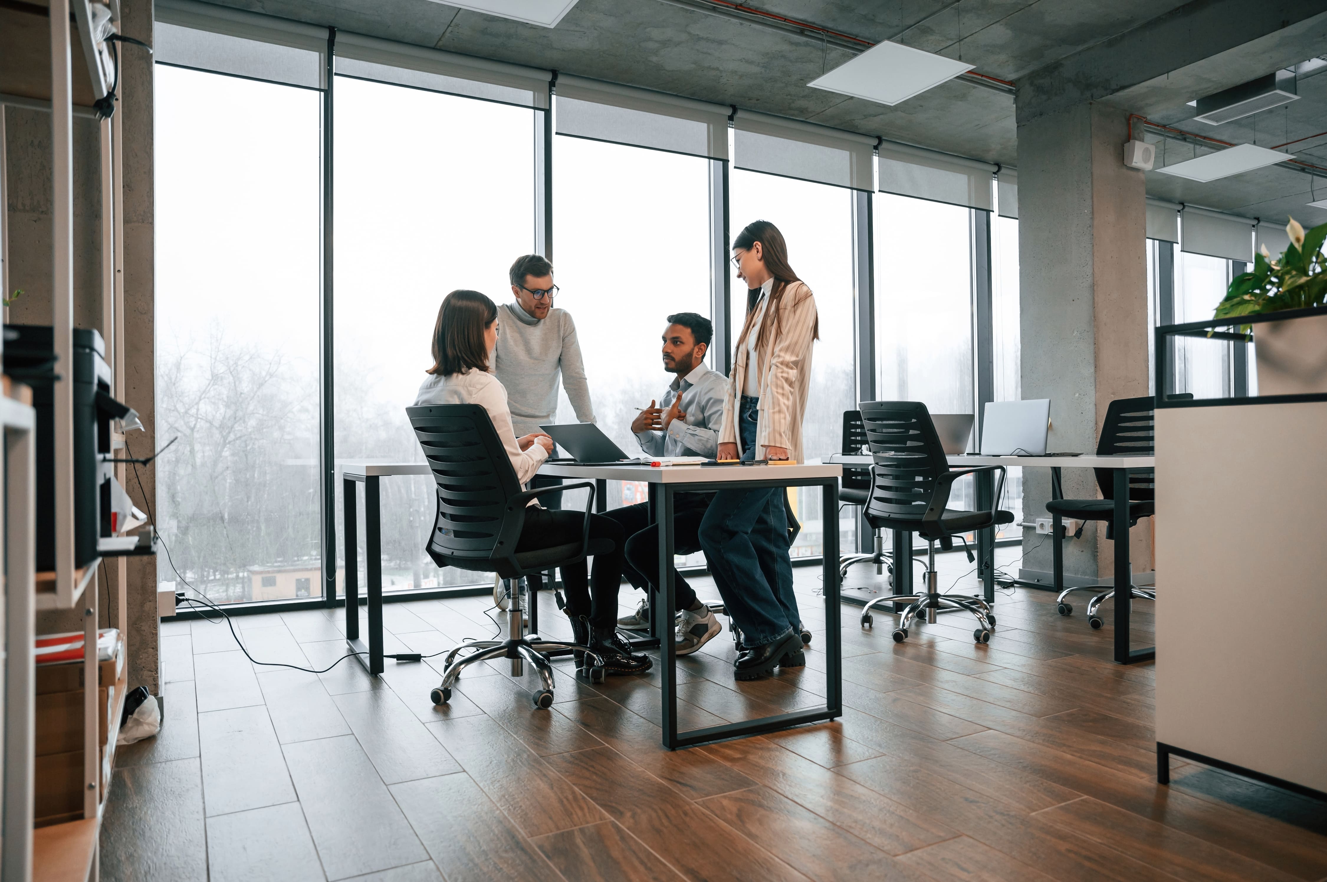 A business team in an office meeting to evaluate and choose a web development company.